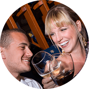 Young couple toasting with glasses of wine