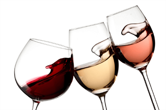 Three wine glasses with a variety of wines in them